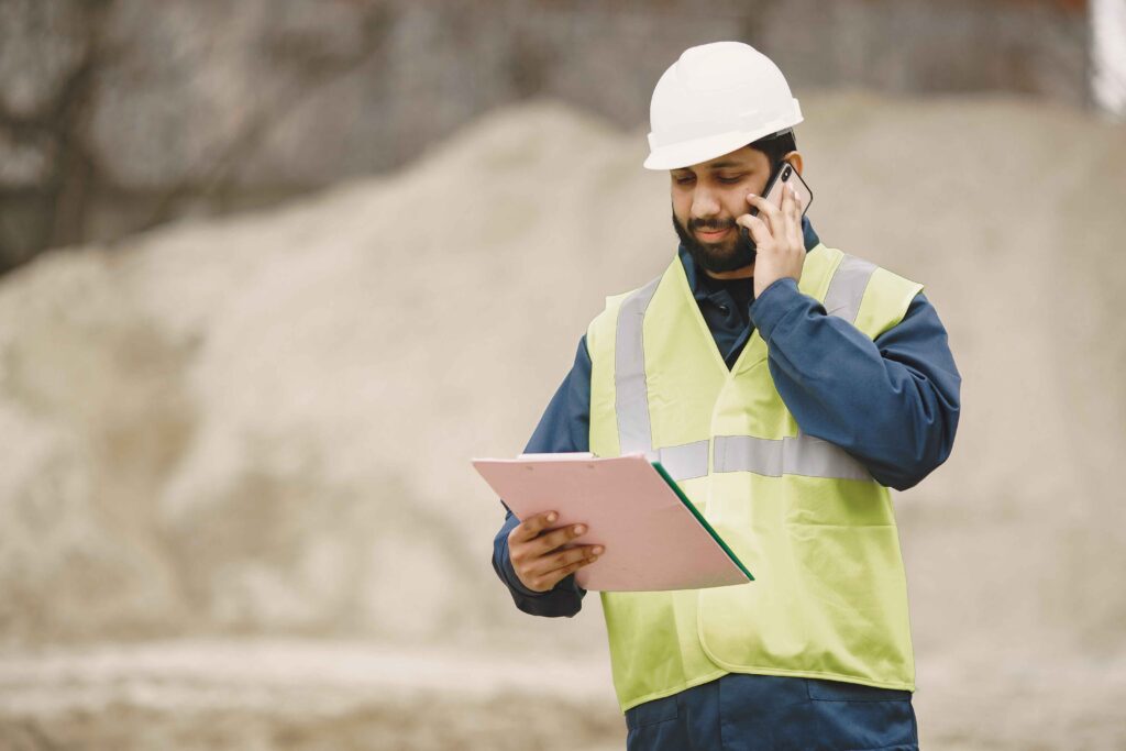 A construction worker calling a client